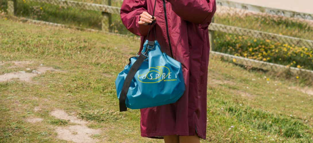 A photo of someone holding a teal changing bag 