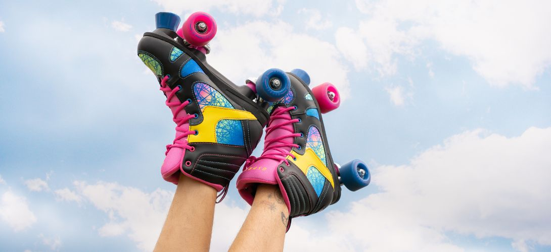 A photo of Osprey Spectrum Quad Skates with blue sky and clouds in the background