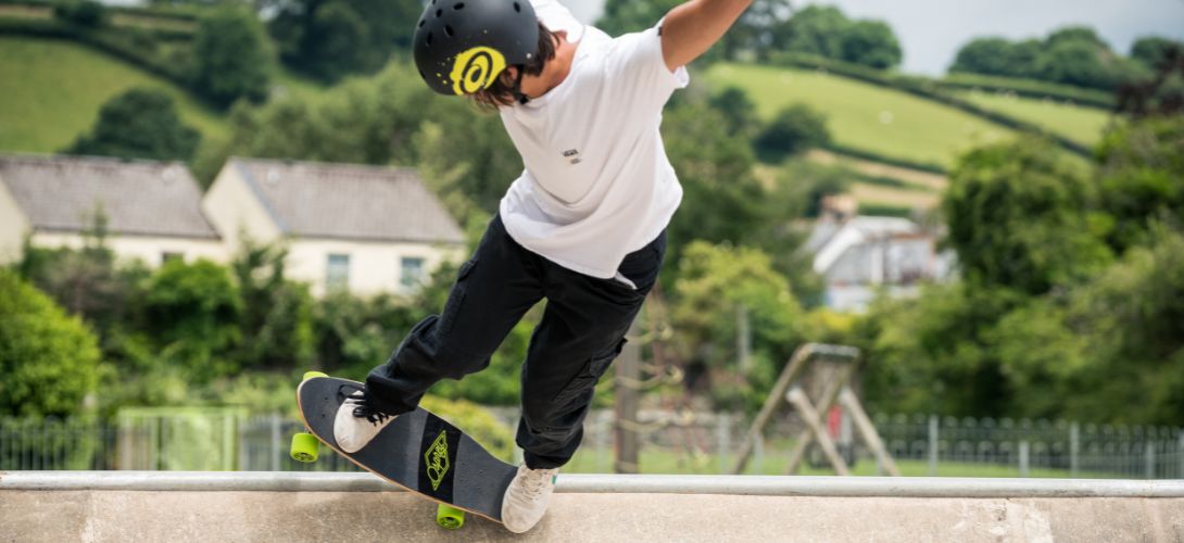 A photo of a man performing a trick at a skate park on an Osprey cruiser board