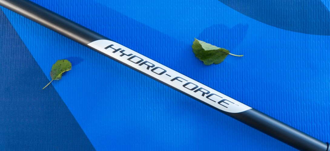 A photo of a Hydro-Force paddle rested across a blue paddleboard